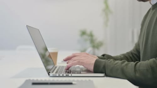Close Up of Young Businessman Working on Laptop