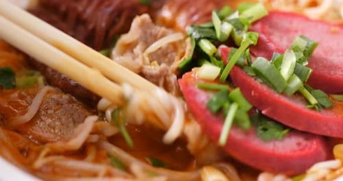 Close Up Of Delicious Noodles With Chopsticks