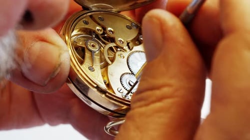 Close-up of Watchmaker Repairing Intricate Clock Mechanism