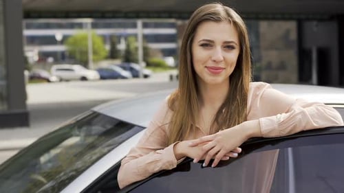 Attractive Young Woman Posing By Silver Car