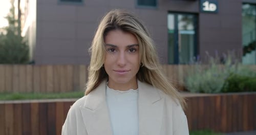Portrait of Attractive Young Woman with Long Blond Hair Looking and Posing To Camera. Crop View