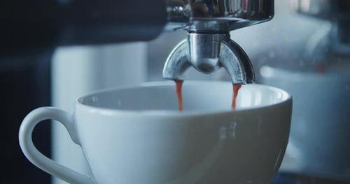 Espresso Pours Into Coffee Cup Close Up