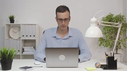 Man Working From Office Using Laptop