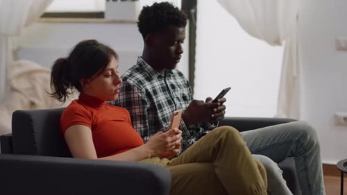 Couple Relaxing at Home Using Mobile Phones