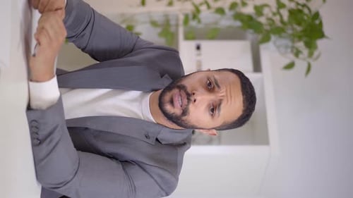 Man in Suit Discussing Business at Office Desk