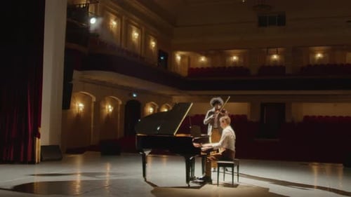 Musicians Playing Violin and Grand Piano in Concert Hall