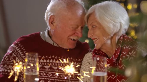Senior Couple Celebrating with Sparklers at Home