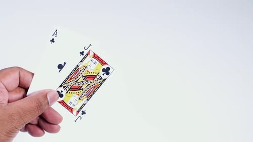 Hand Holds Black Jack Clubs
