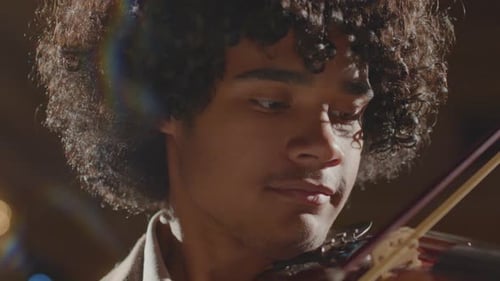 Young Musician Plays Violin in Close Up