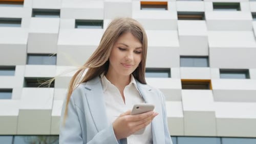 Woman Using Smartphone in City Business Environment