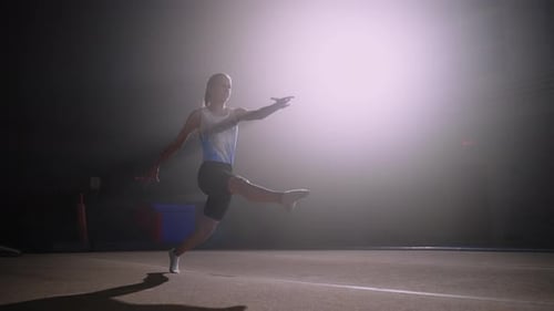 Athletic Teen Girl is Training in Gymnastic Hall Performing Floor Exercise Jumping Over Spring Floor