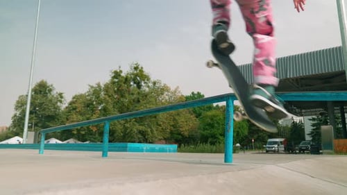 Skateboarder Grinding Rail at Urban Skatepark