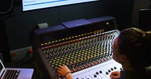 Male audio engineer using sound mixer