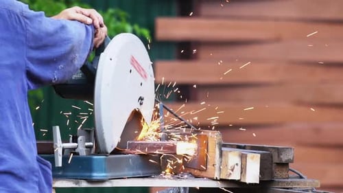 People Cutting Metal Saw for Welding Sparks Material. Worke Tool Sawing Close Up