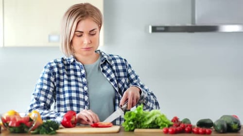 Woman Chopping Vegetables in a Modern Kitchen
