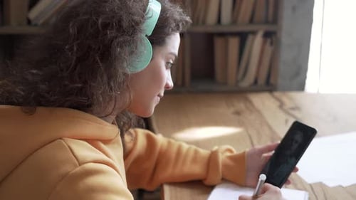Teen Girl School Student Wear Headphones Hold Mobile Phone Learning Online with Teacher