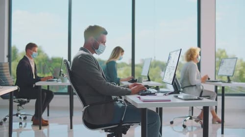 People Wearing Face Masks Working in Modern Office