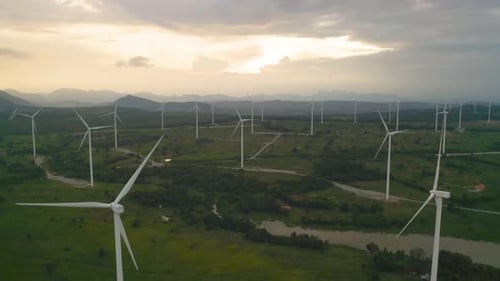 Aerial view of wind turbines or windmills farm field in industry factory. Power, sustainable green