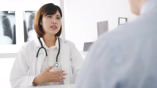 Doctor Explains Diagnosis to Patient in Office