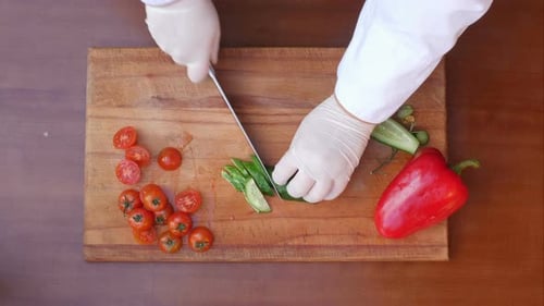 Vegetables Being Sliced on Wooden Cutting Board