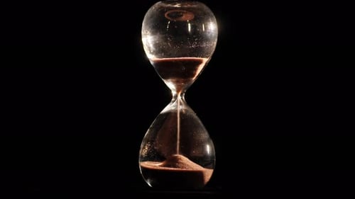 Glass Hourglass on a Black Background
