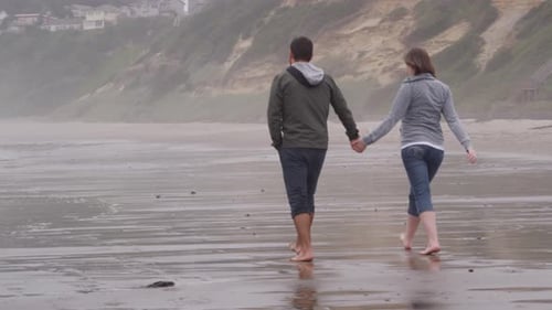 Couple walking at beach together. Shot on RED EPIC for high quality 4K, UHD, Ultra HD resolution.