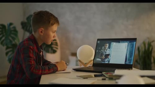 Boy Watching Math Lesson on Laptop at Home