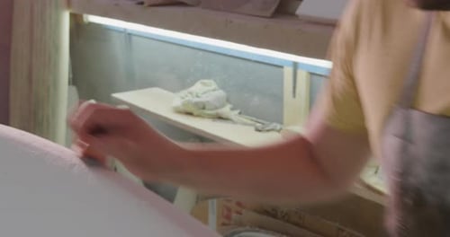 Male surfboard maker in his workshop