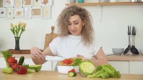 Woman Preparing Healthy Salad in Bright Kitchen