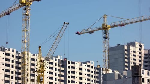 Urban Buildings Construction with Yellow Cranes