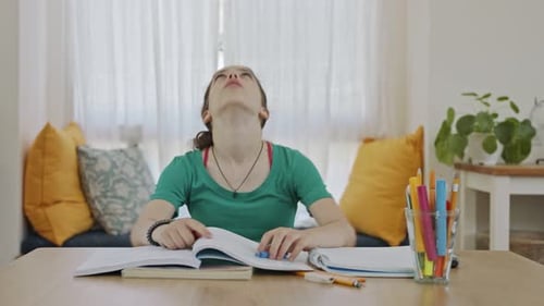 Frustrated teen girl trying and failing to prepare homework for school