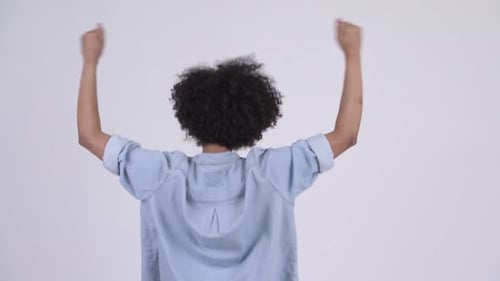 Rear View of Young Happy African Woman with Fists Raised