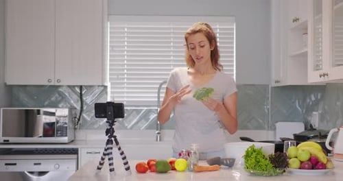 Woman with Produce Films in Bright Kitchen