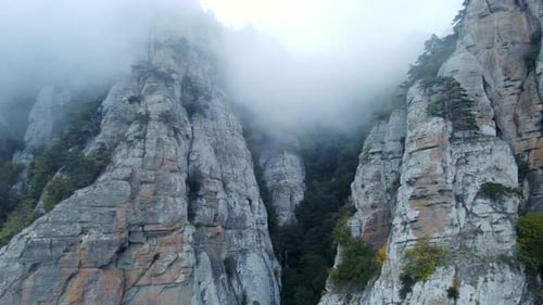 Mountains with Rocky Sculptures That are Getting Covered By Clouds