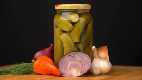 Footage Glass Jars with Salted Vegetables for the Winter Rotated on Table.