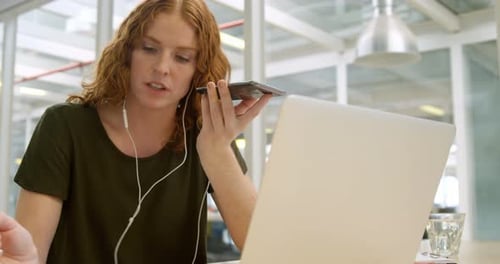 Young Woman Works with Laptop and Smartphone