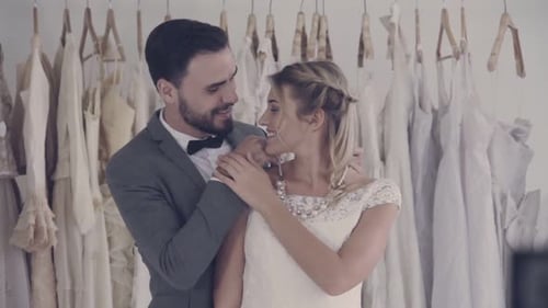 Loving Couple Embracing in Bridal Shop Setting