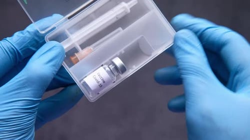Doctor Hand in Protective Gloves Holding Coronavirus Vaccine, Top View