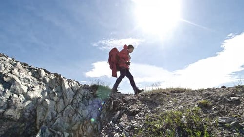 Woman Hiker Walking Along Mountain Ridge