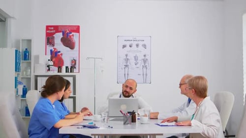 Medical Team Meeting with Laptop in Hospital