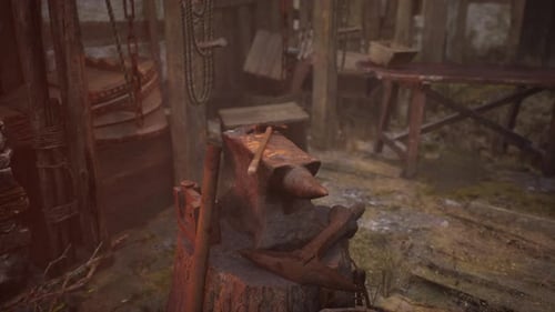 Old Abandoned Blacksmiths Workshop with Rusted Anvil Hammer and Tools