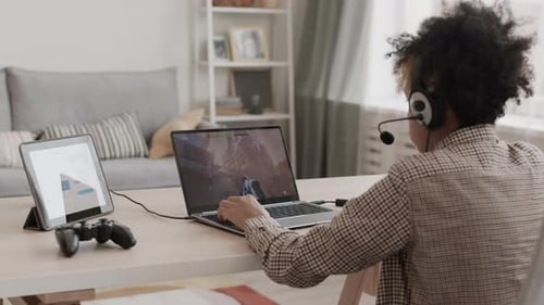 Young Adult Plays Video Game at Home