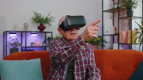 Senior Man Experiencing Virtual Reality Headset Indoors