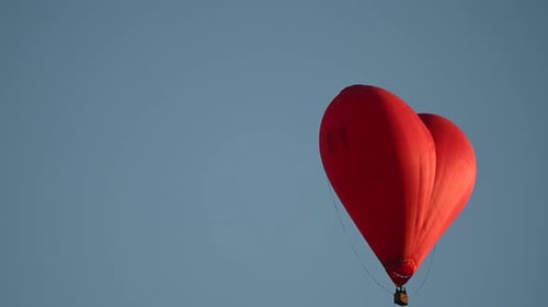 Heart Shaped Balloon Floating in a Blue Sky