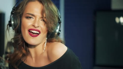 Woman singing in a recording studio. Female vocals. Professional recording studio.