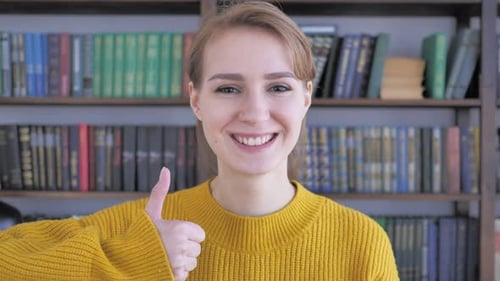 Woman Smiling and Giving Thumbs Up Gesture