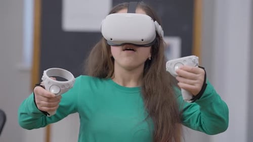 Young Person Experiencing Virtual Reality with Headset and Controllers