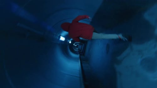Man Running in Dark Underground Tunnel with Blue Light