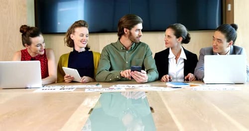 Young Professionals Meeting at Conference Table