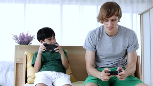 Child and Young Adult Playing Video Game
